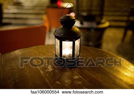 Illuminated lantern on table View Large Photo Image Picture - Illuminated lantern on table. Fotosearch