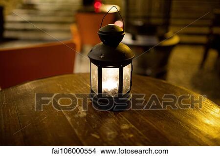 Illuminated lantern on table View Large Photo Image Picture - Illuminated lantern on table. Fotosearch