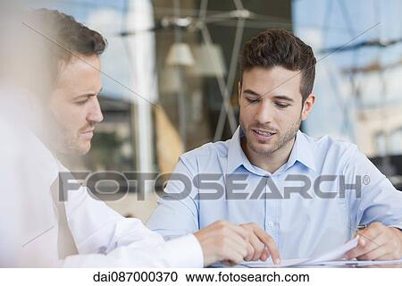 Insurance agent explaining contact to client View Large Photo Image Stock Image - Insurance agent explaining contact to client. Fotosearch