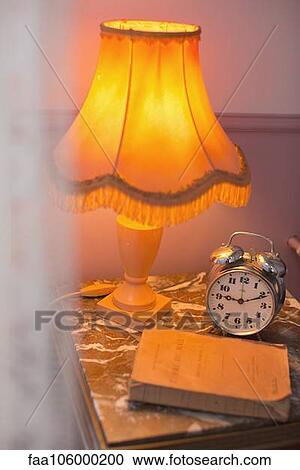 Lamp, alarm clock on bedside table View Large Photo Image Stock Image - Lamp, alarm clock on bedside table. Fotosearch