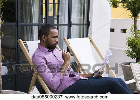 Stock Photo - Lawyer reviewing document. Fotosearch