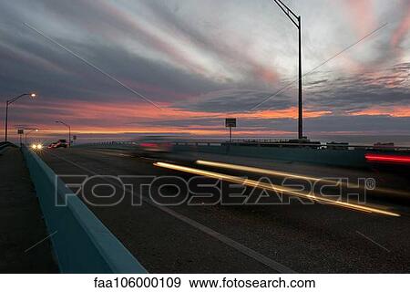 Light trails from traffic on highway at sunset View Large Photo Image Stock Photo - Light trails from traffic on highway at sunset. Fotosearch