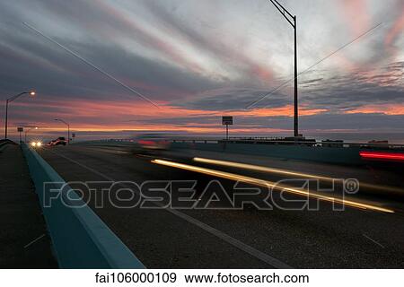 Light trails from traffic on highway at sunset View Large Photo Image Stock Photo - Light trails from traffic on highway at sunset. Fotosearch