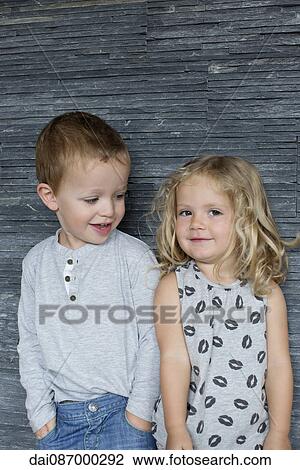 Little boy and little girl standing side by side, portrait View Large Photo Image Stock Image - Little boy and little girl standing side by side, portrait. Fotosearch