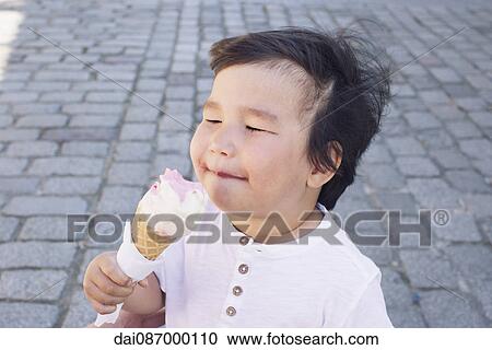 Little boy eating ice cream cone View Large Photo Image Stock Image - Little boy eating ice cream cone. Fotosearch
