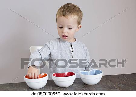 Little boy reaching into bowl View Large Photo Image Stock Image - Little boy reaching into bowl. Fotosearch