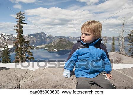 Little boy sitting at Crater Lake National Park in Oregon, USA View Large Photo Image Stock Image - Little boy sitting at Crater Lake National Park in Oregon, USA. Fotosearch