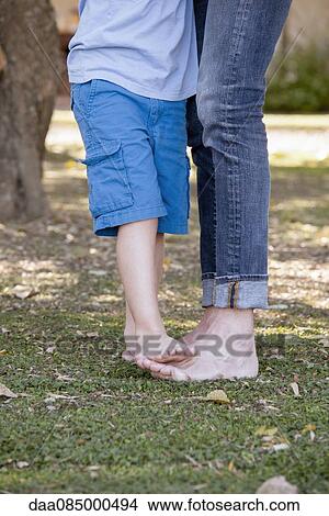 Little boy standing on father's feet View Large Photo Image Picture - Little boy standing on father's feet. Fotosearch