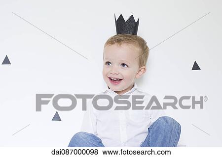Stock Photo - Little boy wearing paper crown. Fotosearch
