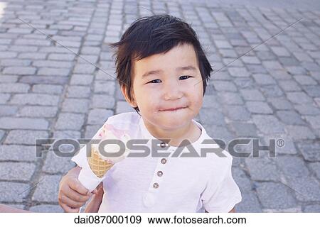 Little boy with ice cream cone, portrait View Large Photo Image Stock Photo - Little boy with ice cream cone, portrait. Fotosearch