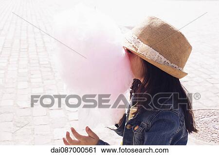 Little girl burying her face in cotton candy View Large Photo Image Stock Image - Little girl burying her face in cotton candy. Fotosearch