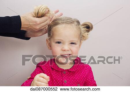 Little girl having her hair arranged in pigtails View Large Photo Image Stock Image - Little girl having her hair arranged in pigtails. Fotosearch