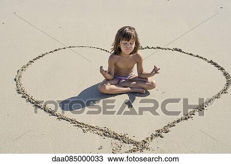 Little girl meditating on beach View Large Photo Image Stock Image - Little girl meditating on beach. Fotosearch