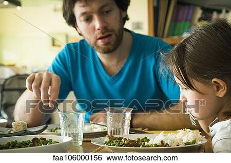 Stock Photograph - Little girl refusing to eat her dinner. Fotosearch