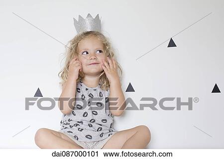 Little girl wearing a paper crown View Large Photo Image Stock Image - Little girl wearing a paper crown. Fotosearch