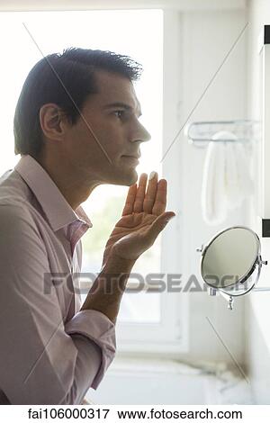 Man applying moisturizer to face View Large Photo Image Stock Photo - Man applying moisturizer to face. Fotosearch