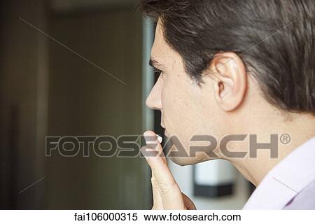 Man applying moisturizer to face View Large Photo Image Stock Photography - Man applying moisturizer to face. Fotosearch