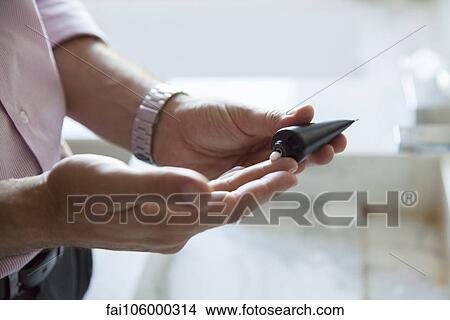 Man applying moisturizer to hands, cropped View Large Photo Image Picture - Man applying moisturizer to hands, cropped. Fotosearch