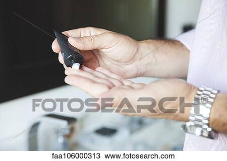 Man applying moisturizer to hands, cropped View Large Photo Image Stock Image - Man applying moisturizer to hands, cropped. Fotosearch