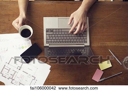 Stock Image - Man at work using laptop. Fotosearch