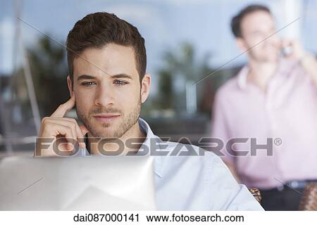 Man contemplating while using laptop computer View Large Photo Image Stock Image - Man contemplating while using laptop computer. Fotosearch
