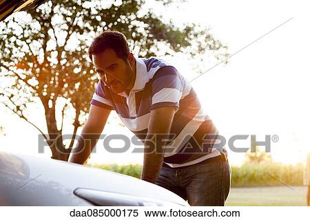 Man experiencing car trouble View Large Photo Image Stock Photography - Man experiencing car trouble. Fotosearch