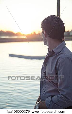 Man looking at sunset View Large Photo Image Stock Photo - Man looking at sunset. Fotosearch