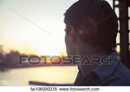 Man looking at sunset View Large Photo Image Stock Photo - Man looking at sunset. Fotosearch