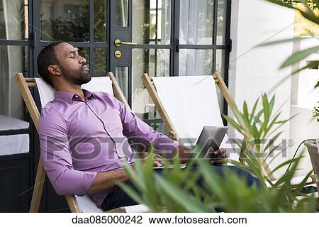 Man napping in deckchair View Large Photo Image Stock Image - Man napping in deckchair. Fotosearch