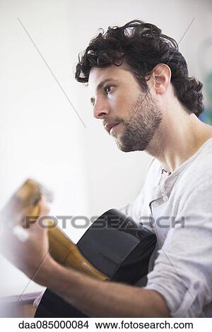 Man playing acoustic guitar View Large Photo Image Picture - Man playing acoustic guitar. Fotosearch