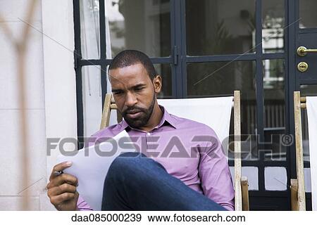 Stock Photo - Man reading letter. Fotosearch