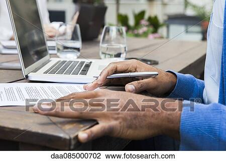 Man reviewing document View Large Photo Image Stock Image - Man reviewing document. Fotosearch