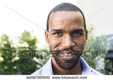 Stock Image - Man smiling, portrait. Fotosearch