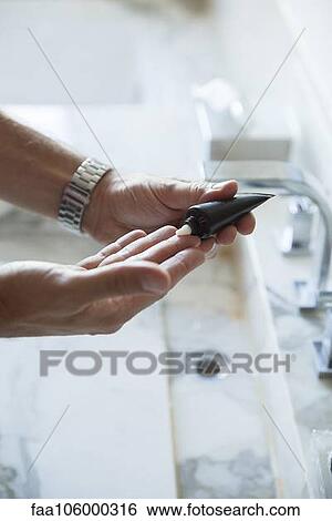 Man squeezing moisturizer out of tube, cropped View Large Photo Image Stock Photograph - Man squeezing moisturizer out of tube, cropped. Fotosearch