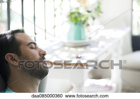 Stock Image - Man taking nap. Fotosearch