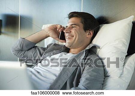 Man talking on cell phone, smiling cheerfully View Large Photo Image Stock Photo - Man talking on cell phone, smiling cheerfully. Fotosearch