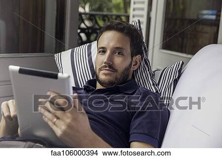 Man using digital tablet View Large Photo Image Picture - Man using digital tablet. Fotosearch