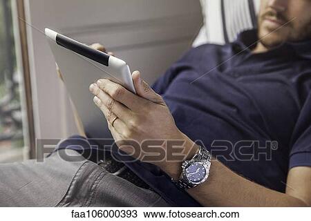Man using digital tablet View Large Photo Image Stock Image - Man using digital tablet. Fotosearch