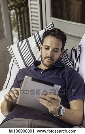 Man using digital tablet View Large Photo Image Stock Image - Man using digital tablet. Fotosearch