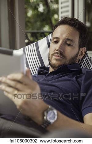 Stock Image - Man using digital tablet. Fotosearch