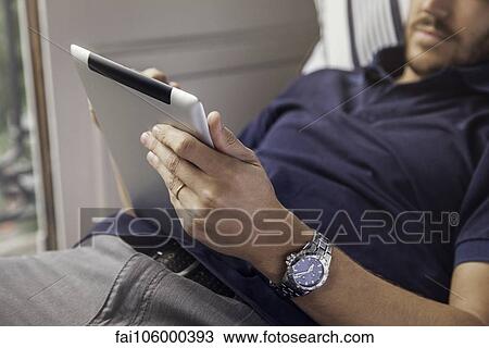 Man using digital tablet View Large Photo Image Stock Image - Man using digital tablet. Fotosearch