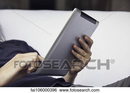 Stock Photograph - Man using digital tablet. Fotosearch