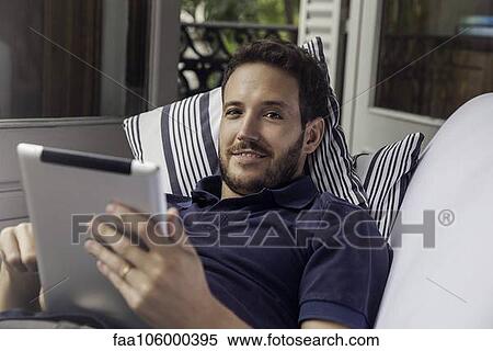 Stock Photography - Man using digital tablet. Fotosearch