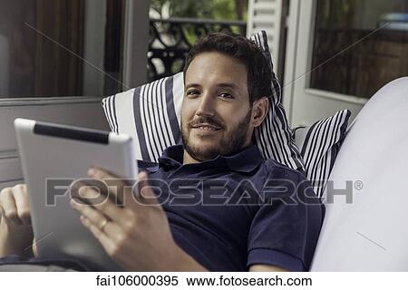 Stock Photography - Man using digital tablet. Fotosearch
