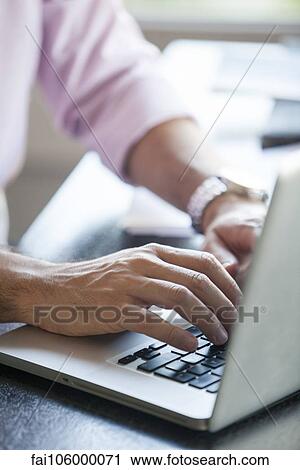 Man using laptop computer, cropped View Large Photo Image Stock Image - Man using laptop computer, cropped. Fotosearch