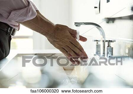 Man washing hands in bathroom sink, cropped View Large Photo Image Stock Image - Man washing hands in bathroom sink, cropped. Fotosearch