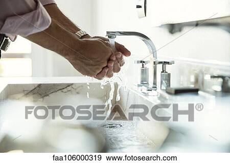 Man washing hands in bathroom sink, cropped View Large Photo Image Stock Photo - Man washing hands in bathroom sink, cropped. Fotosearch