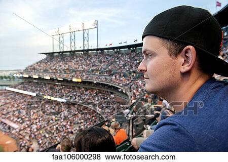 Man watching sports match in stadium View Large Photo Image Stock Photo - Man watching sports match in stadium. Fotosearch