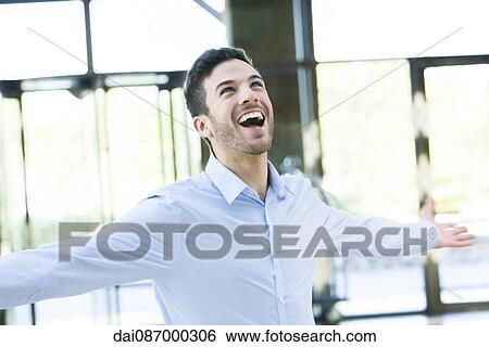 Stock Photograph - Man with arms outstretched. Fotosearch