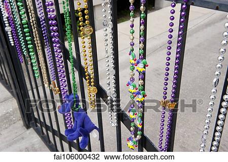 Stock Image - Mardi gras beads hanging on railing in New Orleans, Louisiana, USA. Fotosearch
